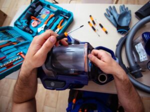 man repairing vacuum - Vacuum Service Richland County, OH