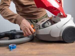 Worker repairing canister vacuum - Vacuum Repair Wayne County, OH